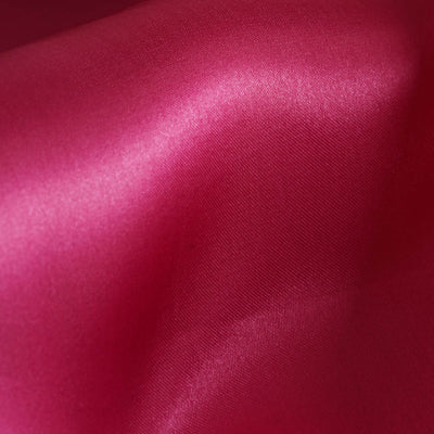 Shiny fuchsia satin fabric with smooth texture and vibrant color.
