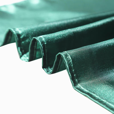 Green satin fabric with smooth texture and elegant drape.