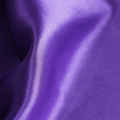 Close-up of luxurious purple satin fabric texture.