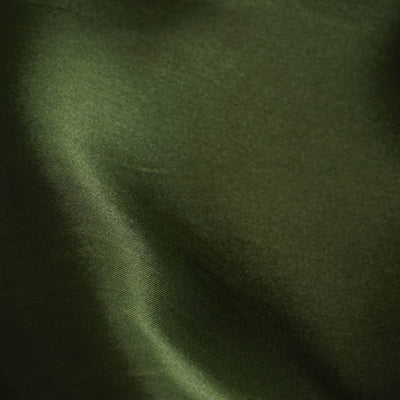 Close-up of smooth, dark green satin fabric texture.