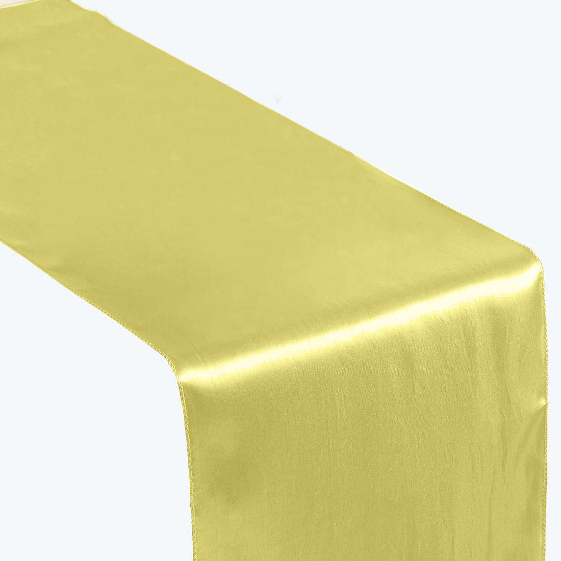 Yellow satin table runner on white backdrop