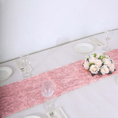 Pink table runner with floral centerpiece on a dining table.