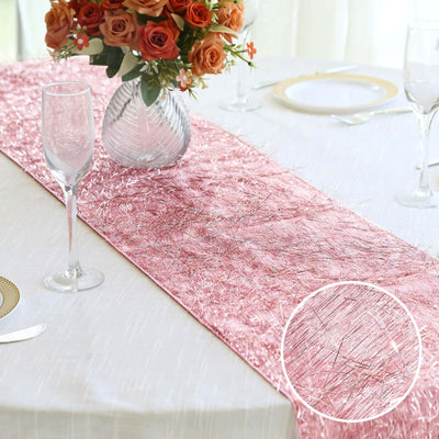 Pink table runner with metallic accents on a dining table setting.