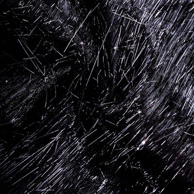 Black fabric with shiny metallic fibers creating a textured pattern.
