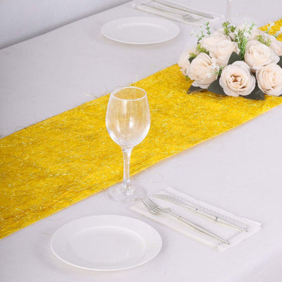 Elegant table setting with a yellow runner, glass, and rose centerpiece.