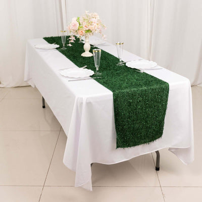 Green table runner on a white dining table set for a formal occasion.
