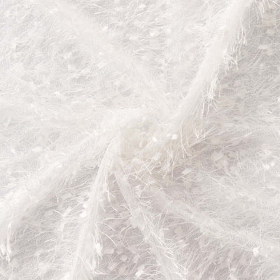 White textured fabric with delicate embellishments.