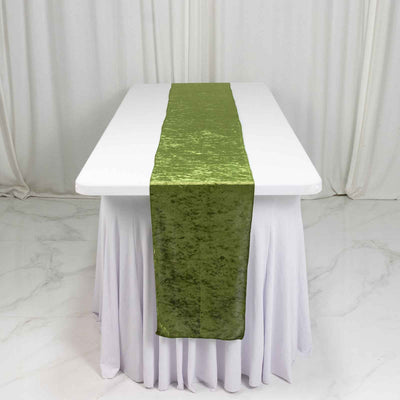 Green velvet table runner on a white draped table in a minimalist setting