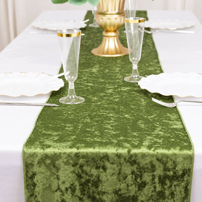 Green velvet table runner with gold accents on a formal dining table
