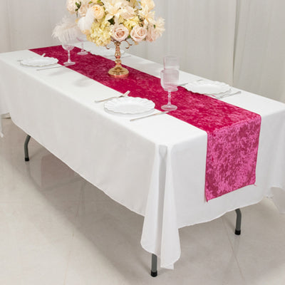 Table set with a white tablecloth and a pink runner, featuring floral decor.