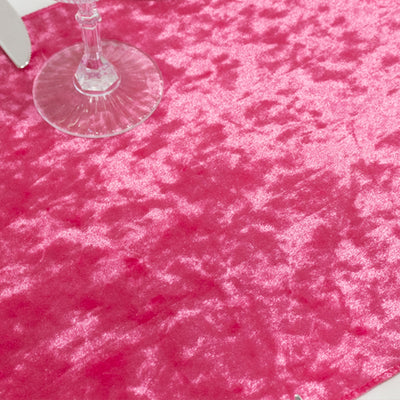 Pink textured fabric surface with a glass on top.