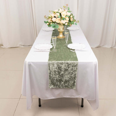 Elegant table setting with floral centerpiece and green runner.