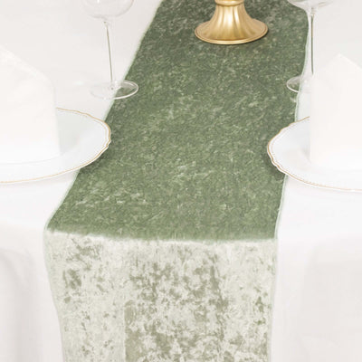 Green table runner on a white table setting with elegant dinnerware.
