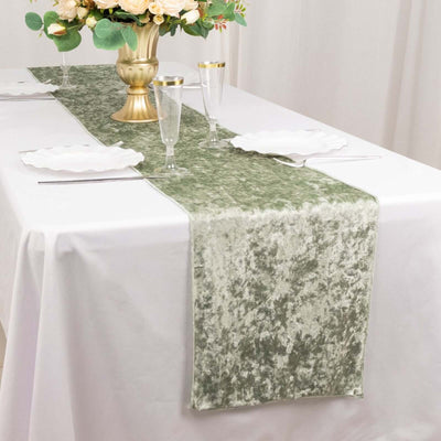 Green velvet table runner on a dining table with elegant glassware and plates.