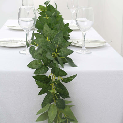 Artificial green leaf garland for table decor with wine glasses and plates
