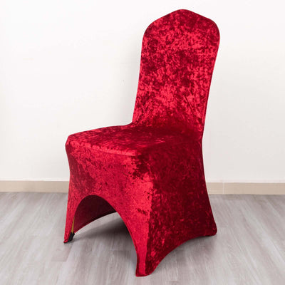 Red velvet chair cover on a plain background.