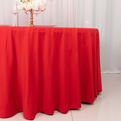Red tablecloth with elegant draping, perfect for events and dining settings.