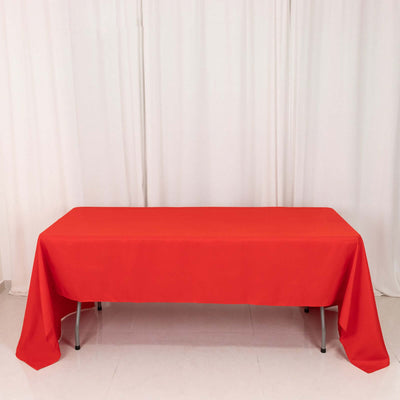 Red tablecloth draped over a table in a studio setting.