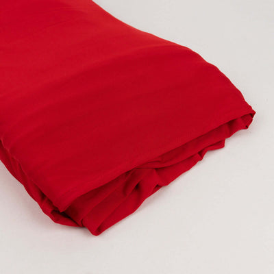 Red fabric roll on a plain background