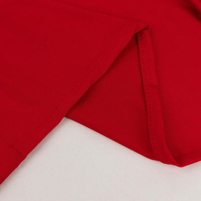 Red fabric corner showing smooth texture and stitching detail.