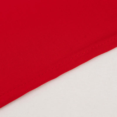 Close-up of vibrant red fabric showcasing smooth texture and stitching details.