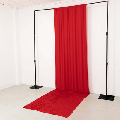 Red fabric backdrop draped on a frame in a studio setting.