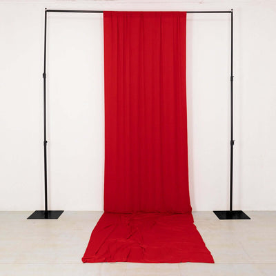 Red fabric backdrop with draped texture on a plain background.