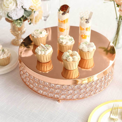 Rose gold dessert stand with cupcakes and elegant decor.
