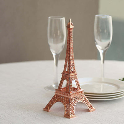 Eiffel Tower decorative figurine on a table with glassware and plates.
