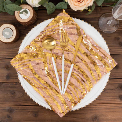 Sequin napkin with gold utensils on a decorative plate.