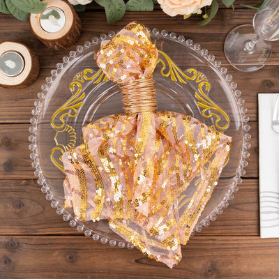 Gold sequin table napkin wrapped with wire on a decorative plate.