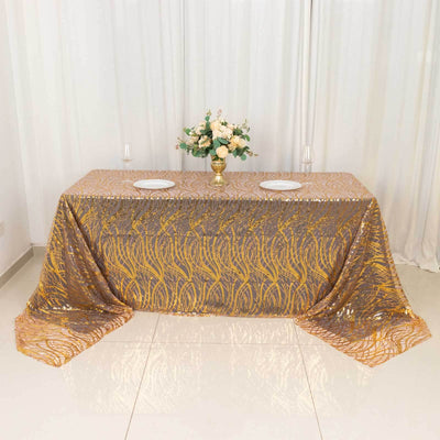 Gold and silver sequined tablecloth on a dining table with floral centerpiece.