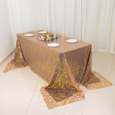 Elegant gold and beige tablecloth draped over a table for an event setting.