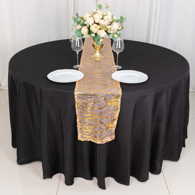 Elegant black table set with gold-accented runner and floral centerpiece.