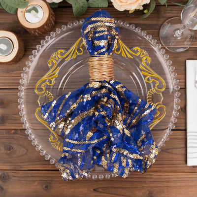 Blue and gold sequin table napkin elegantly arranged on a decorative plate.