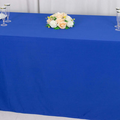 Blue tablecloth with floral centerpiece arranged for an event setup.