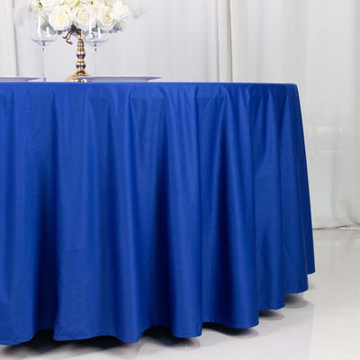 Blue tablecloth draping elegantly over a round table in a decorated setting.
