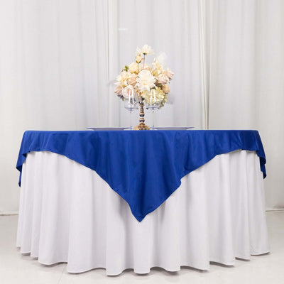 Decorative table setup with blue and white linens and floral centerpiece.