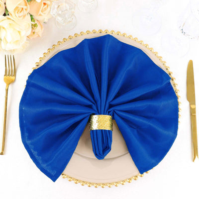 Elegant blue napkin with gold ring on a decorative plate