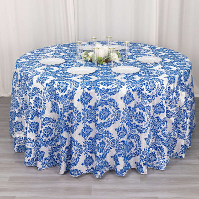Round blue and white floral tablecloth on a gray surface.