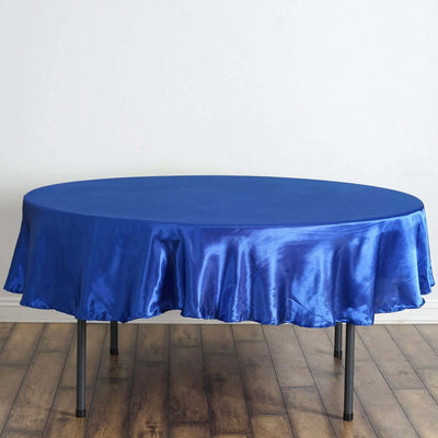 Round blue satin tablecloth draped over a table.
