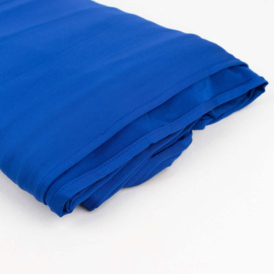 Royal blue fabric folded neatly on a plain backdrop.