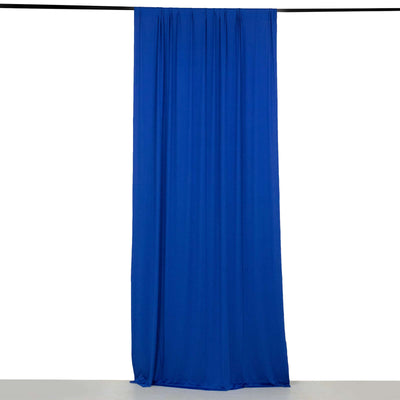 Blue fabric curtain draped elegantly against a plain backdrop.