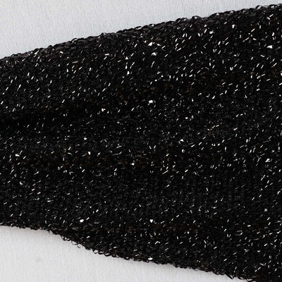 Black textured fabric with shimmering details.