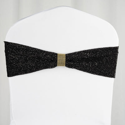 Black glitter chair cover with gold accent bow.