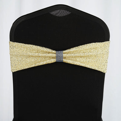 Gold sequin chair cover sash with a jeweled center on a black chair.