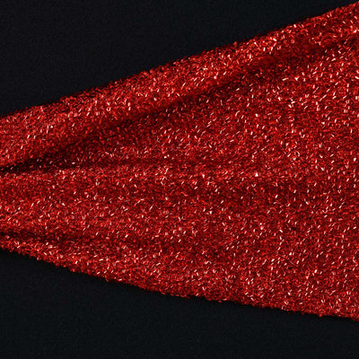 Red glitter fabric texture on a black background.