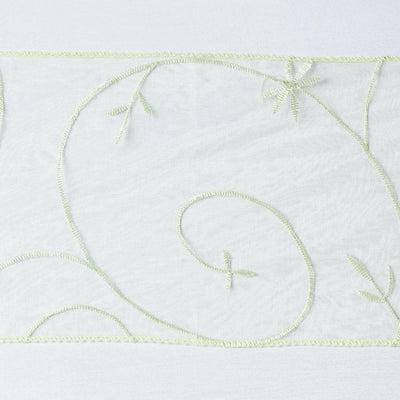 Sheer fabric with intricate green embroidery design
