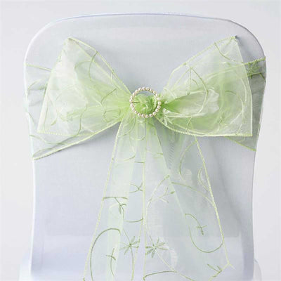 Green sheer chair sash with pearl embellishment on a white chair