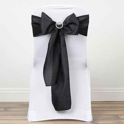 Black satin chair bow with rhinestone embellishment on a white chair